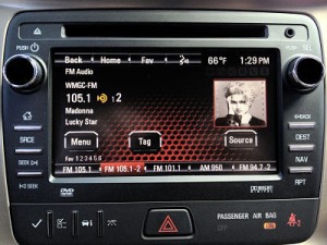 The standard radio on the 2013 GMC Acadia is one of the first to include a new HD Radio feature — the “Artist Experience” display of album cover art, station logos and other information.