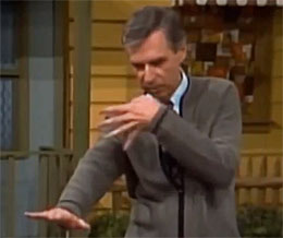 Rogers in cardigan seems to do a dance move