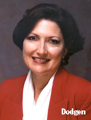 Dodgen, dark haired in white blouse red suit